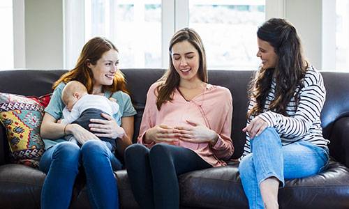 Woman with baby and pregnant woman