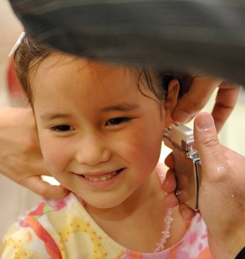 kid ear piercing smiling