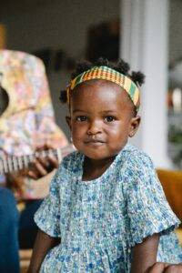 child near person playing guitar-ear-piercing