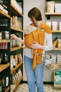 mother carrying newborn baby on her chest