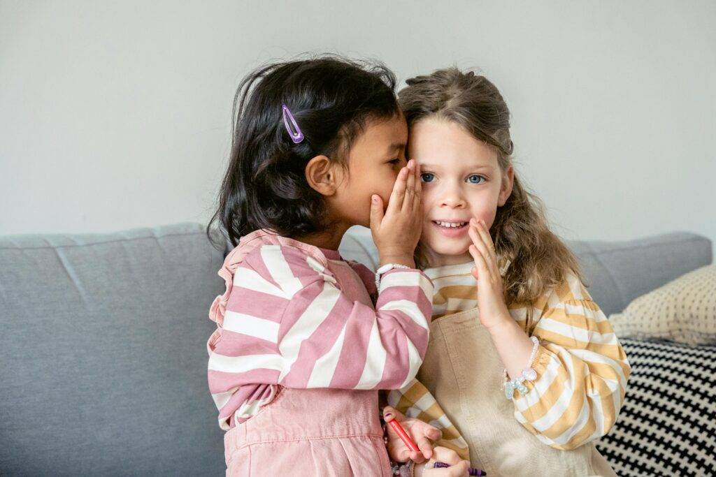 Building a Trusting Relationship with Your Child's Pediatrician 1 child whispers in ears of a trusted friend trust