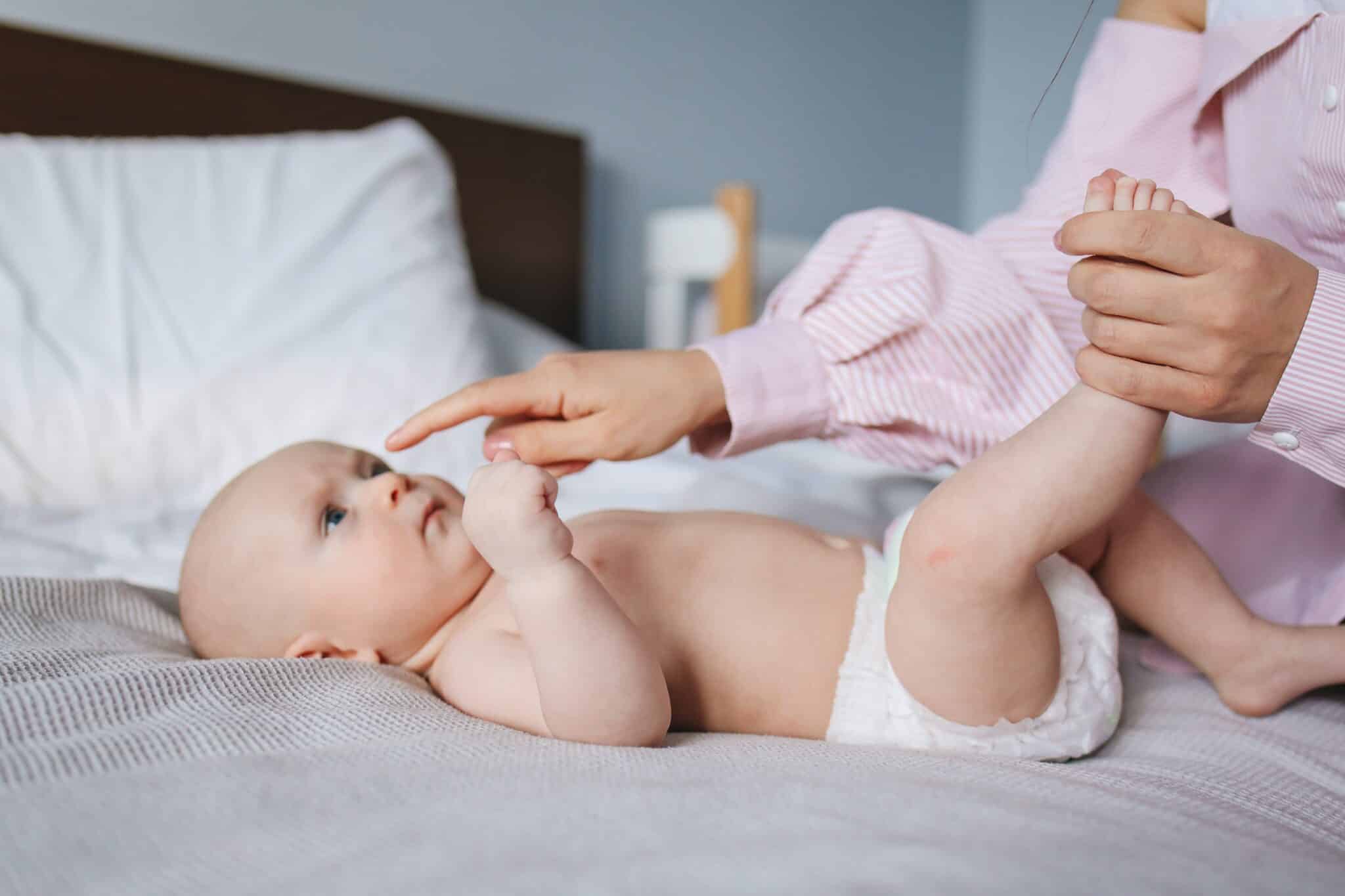 Baby Massage-mother and playing with newborn baby zinc oxide
