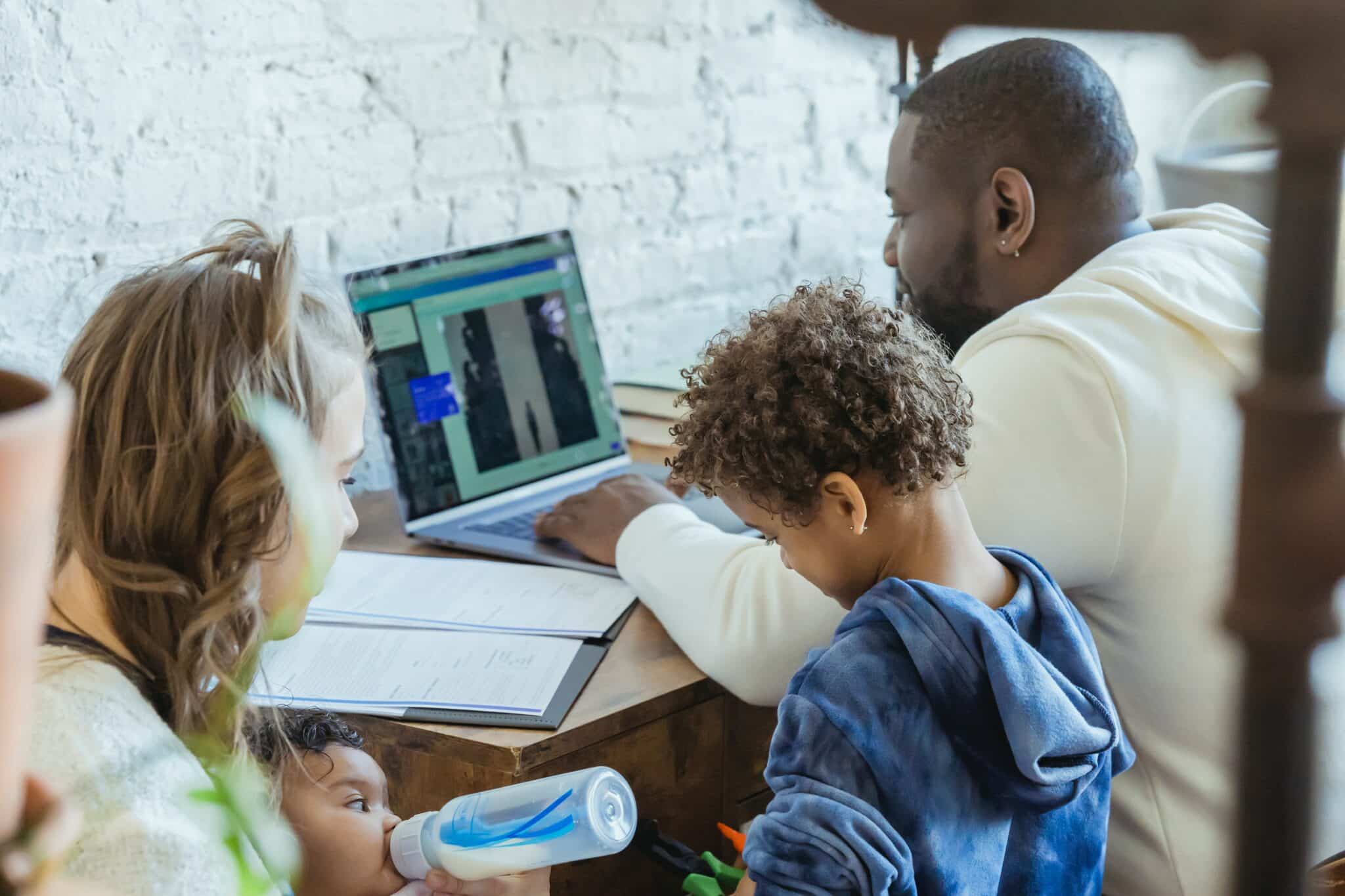 health-plan-mother and children beside the father while working