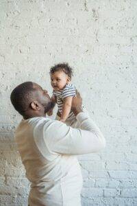 father carrying his lovely baby-eco-friendly parenting