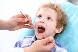 Close up of boy having his teeth examined by a dentist for gingivitis-dental health