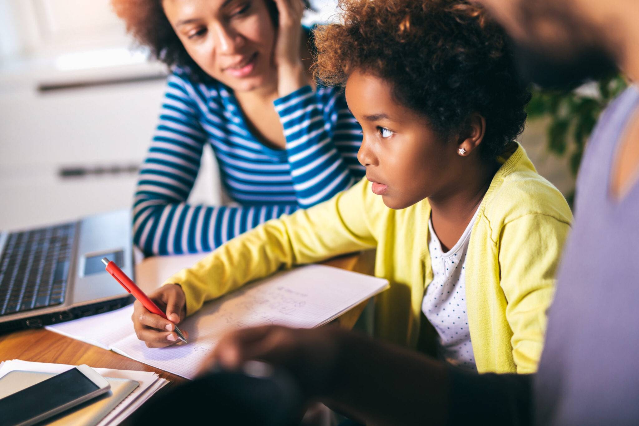 Mother and father helping daughter to do homework learning to calculate school anxiety